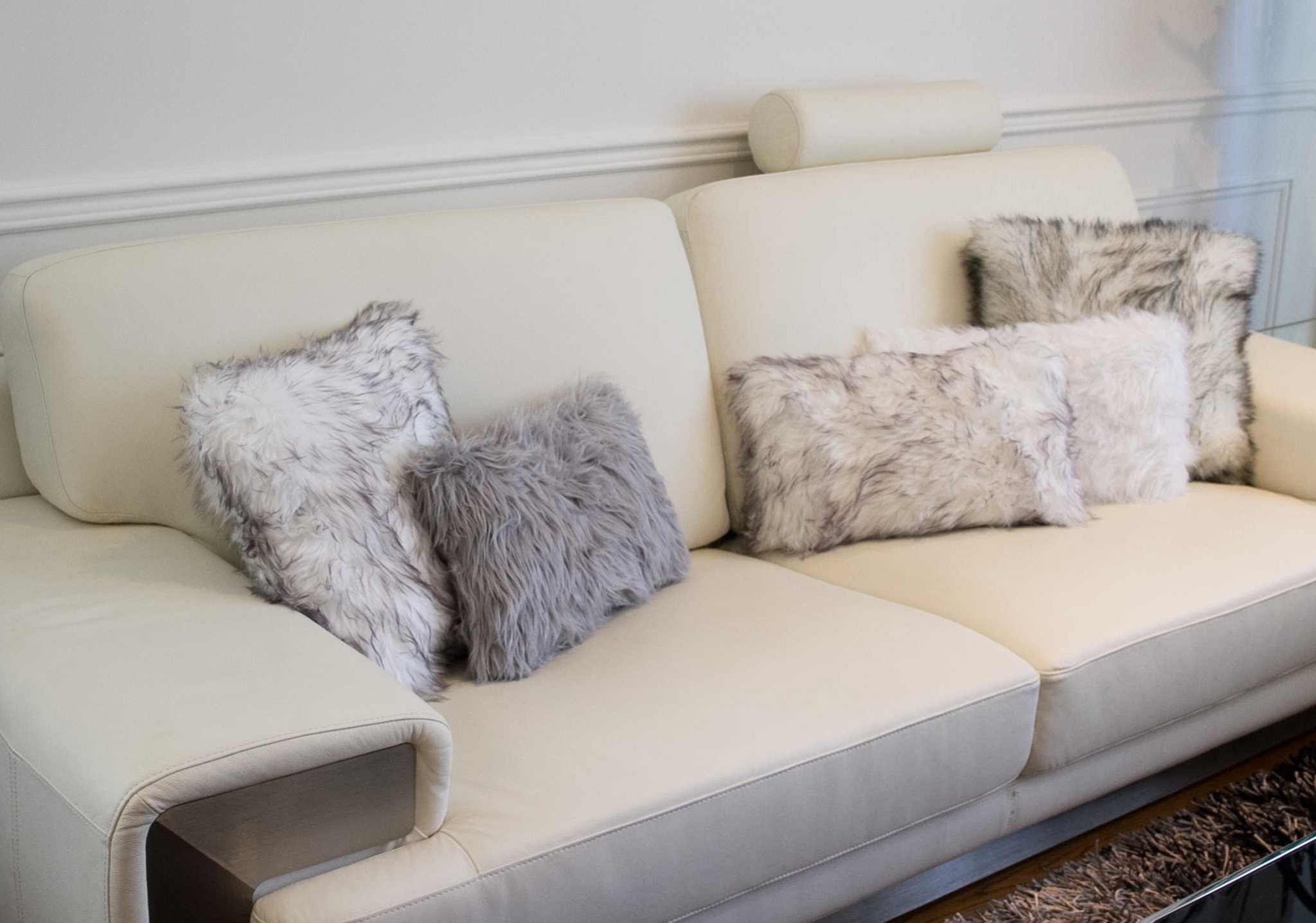 Set of 2 off white cozy faux fur lumbar pillows with plush texture, perfect for home decor and comfort.