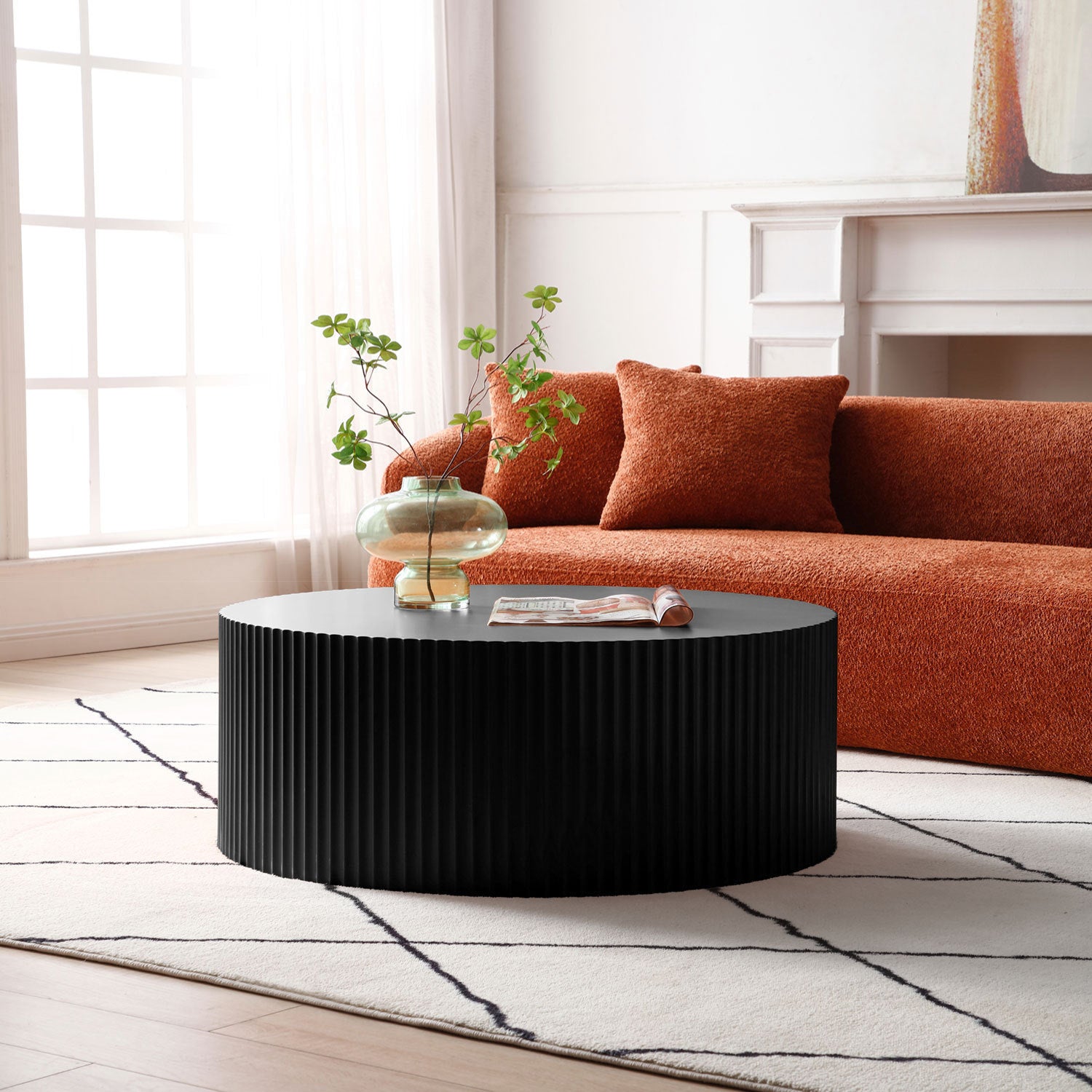 Sleek and modern round coffee table featuring an eye-catching relief design in matt black finish, perfect for contemporary living spaces.