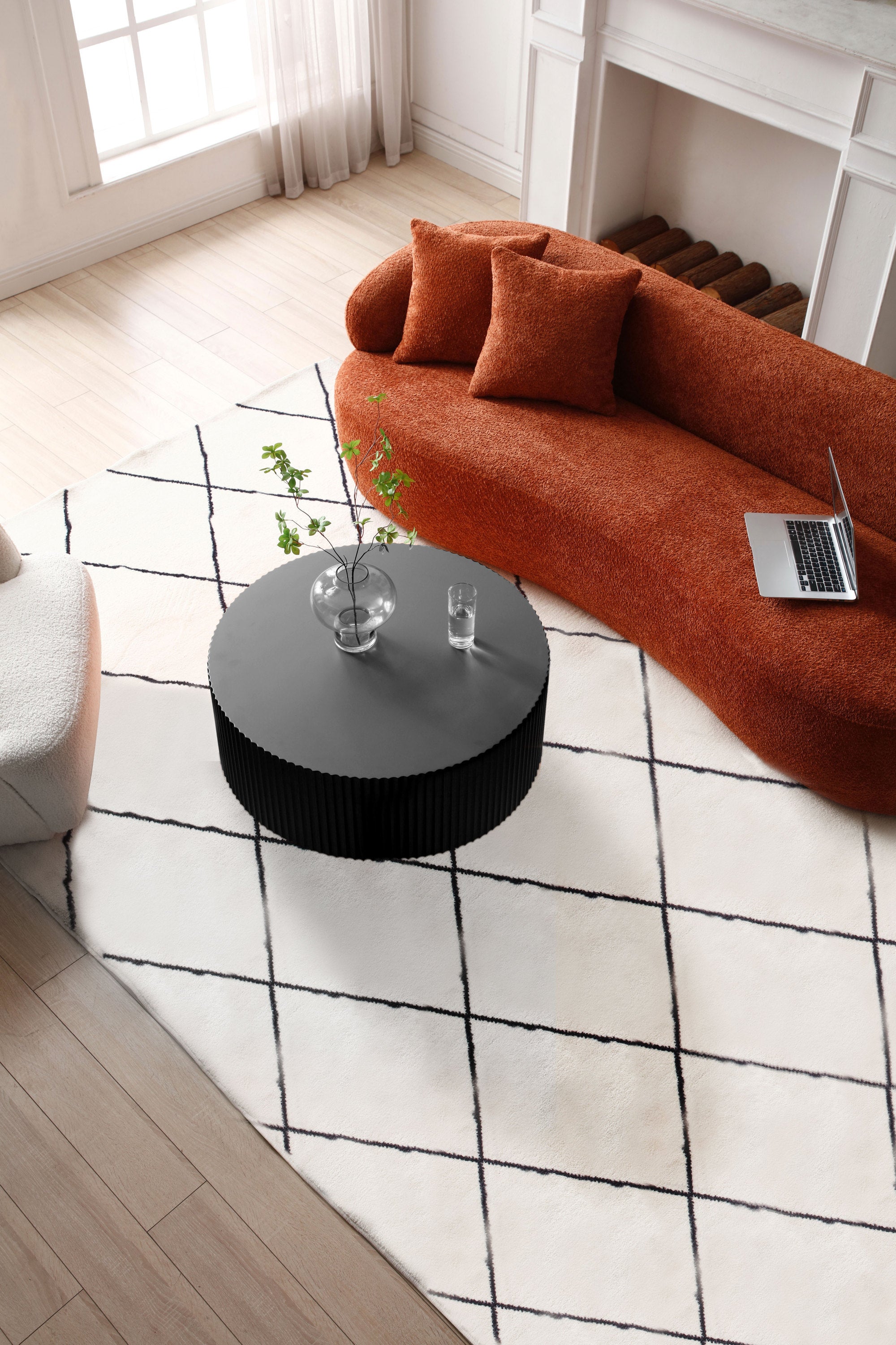 Sleek and modern round coffee table featuring an eye-catching relief design in matt black finish, perfect for contemporary living spaces.