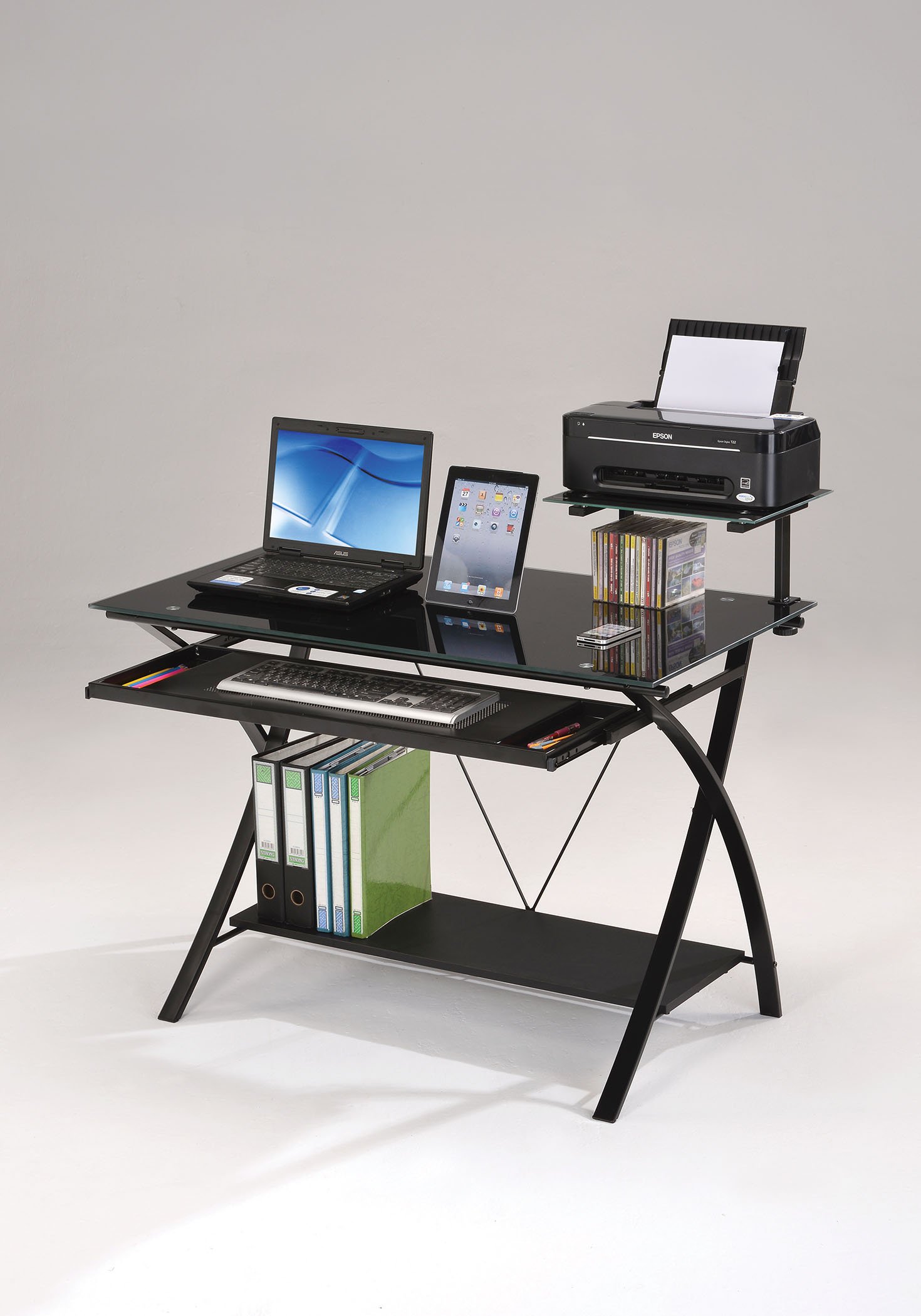 Sleek black glass computer desk with a spacious work surface and sturdy metal base, featuring a pull-out keyboard tray and bottom shelf.