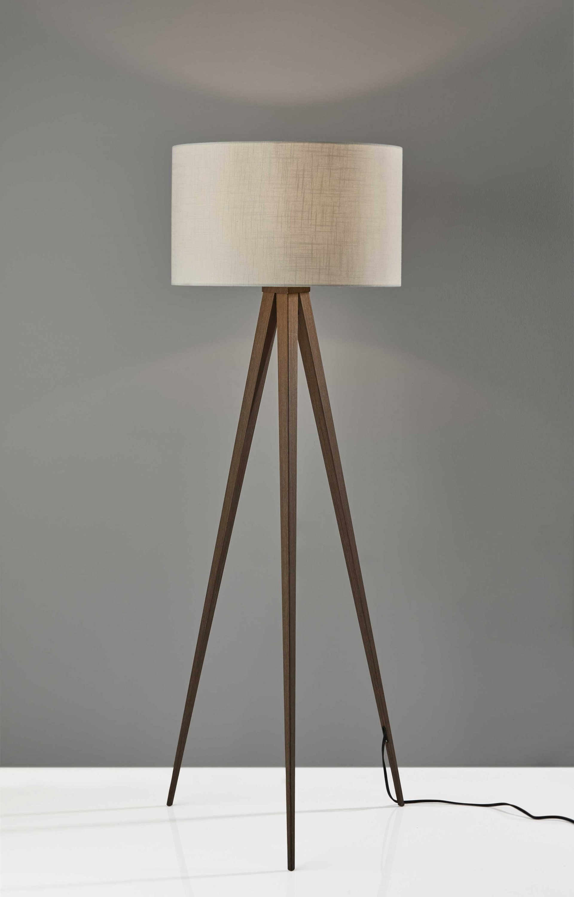 Treble Floor Lamp featuring three black metal tripod legs and a black drum shade, perfect for modern interiors.