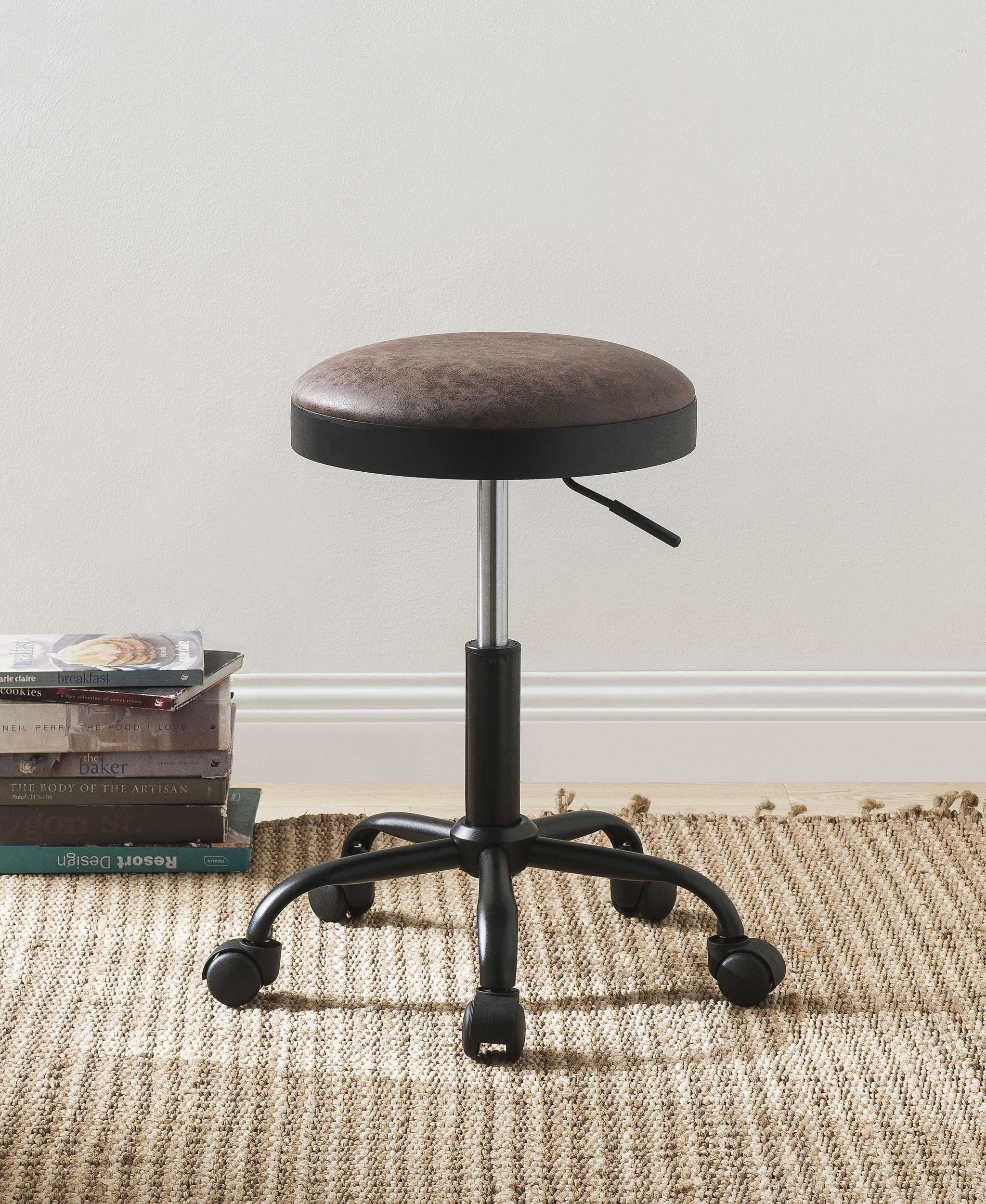 Set of 2 vintage mocha upholstered adjustable bar stools with black metal base and caster wheels.