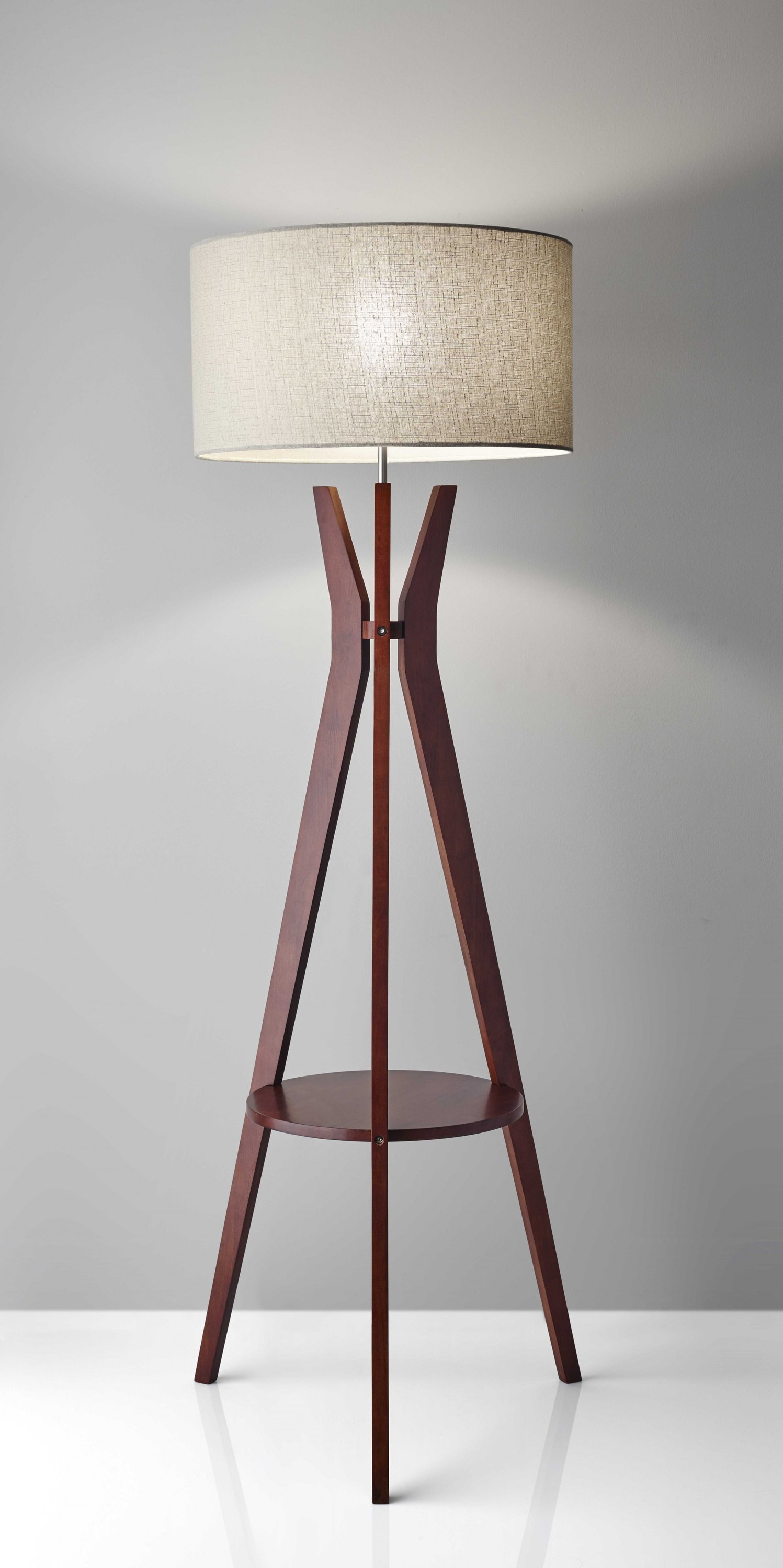 Walnut Wood Floor Lamp with Tripod Base and Oatmeal Linen Shade, featuring a round shelf for storage.