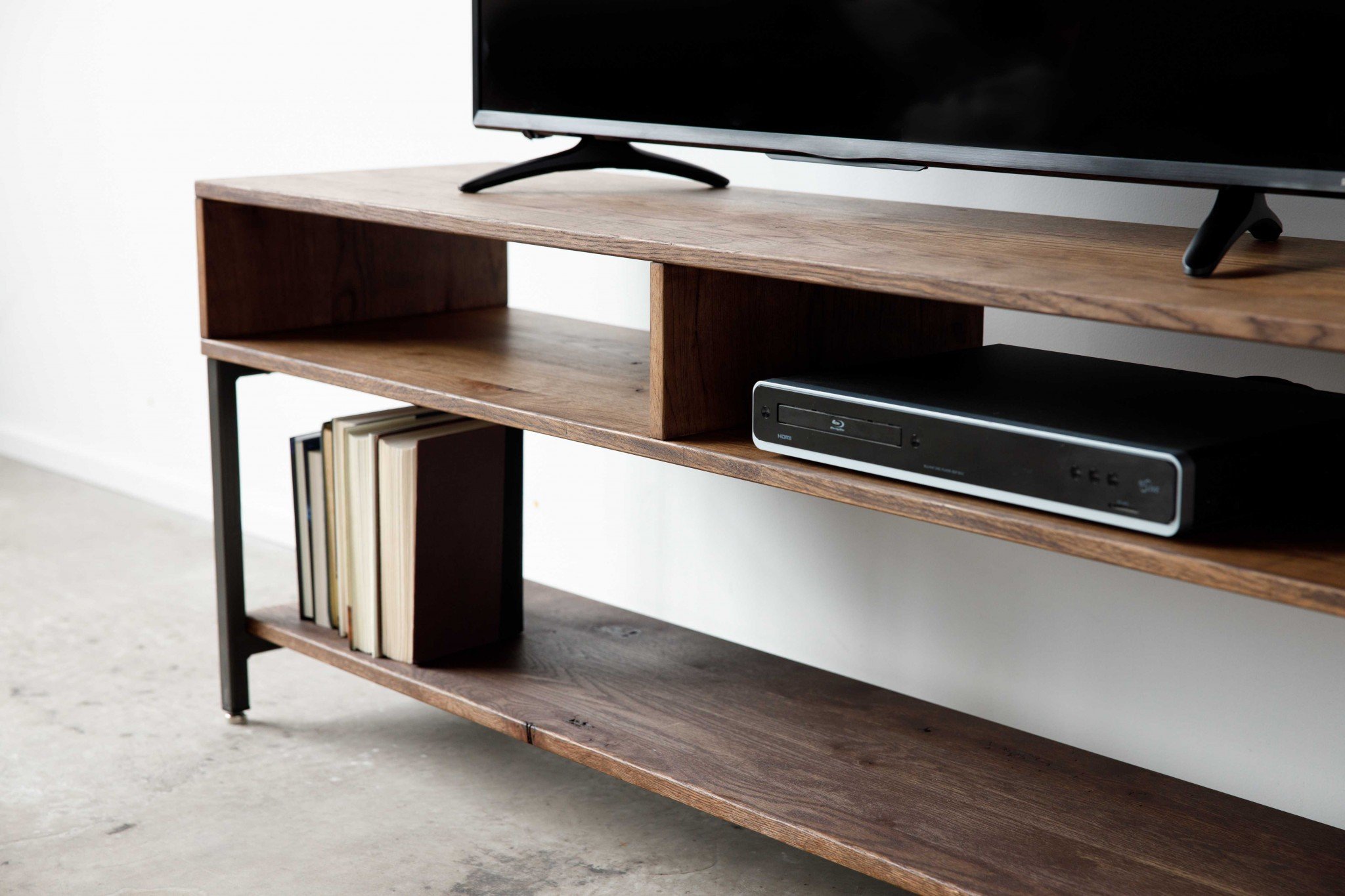 Wooden TV stand with books.