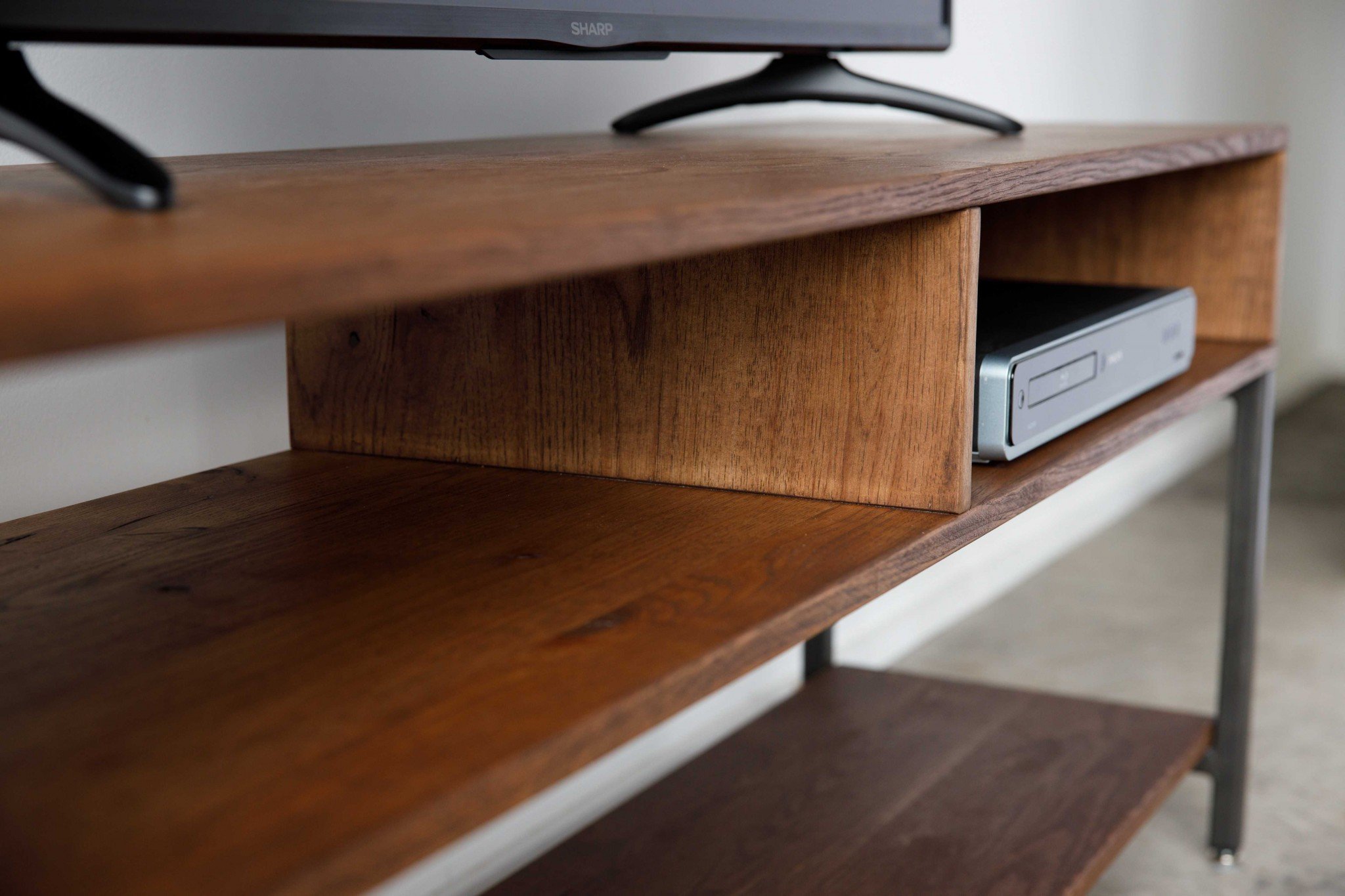 Wooden TV stand with shelves.