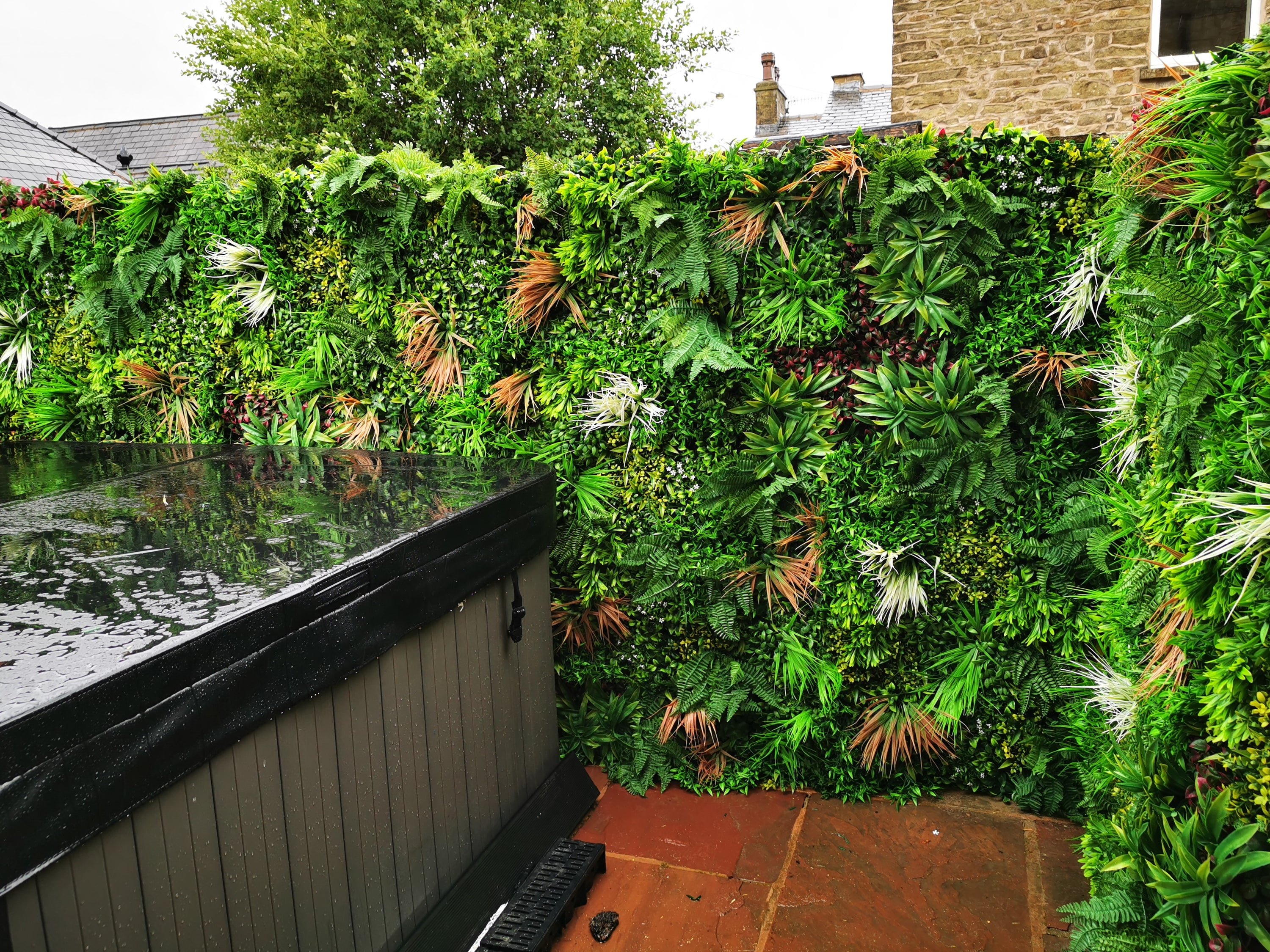 Artificial Deluxe Green Wall featuring lush tropical foliage, 100x100cm size, perfect for enhancing indoor and outdoor spaces.