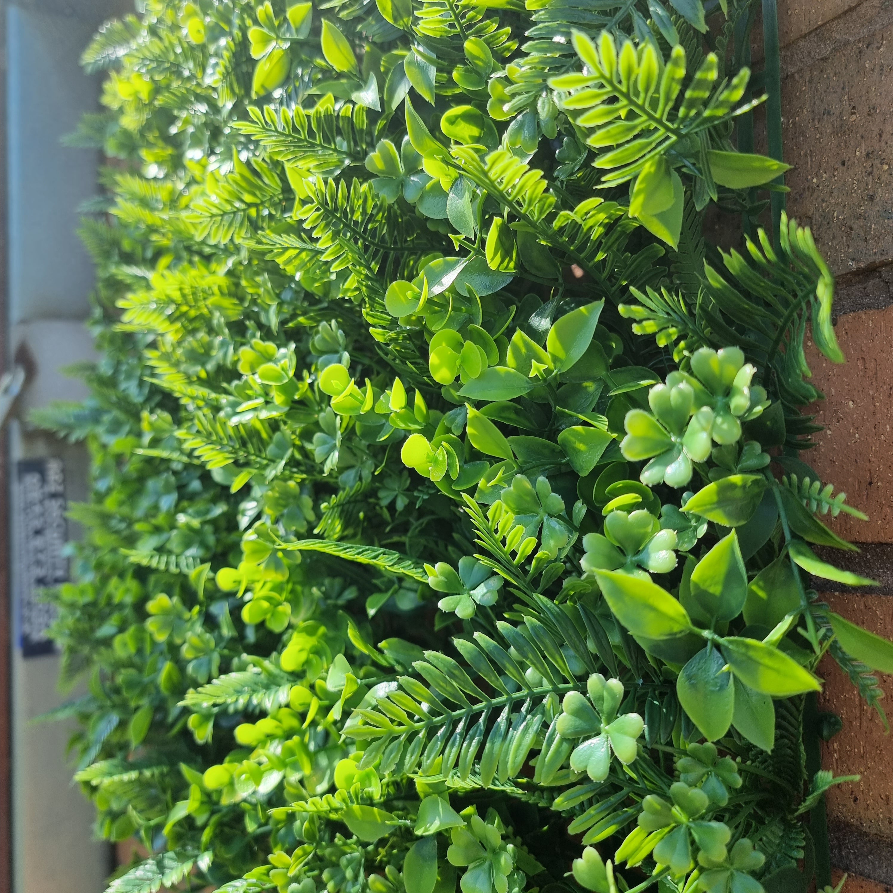 Artificial Tropical Hedge Panel 50x50cm with lush green foliage, designed for realistic appearance and outdoor durability.