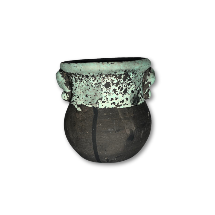 A stylish black pot featuring a unique green sponge pattern, perfect for indoor plants.