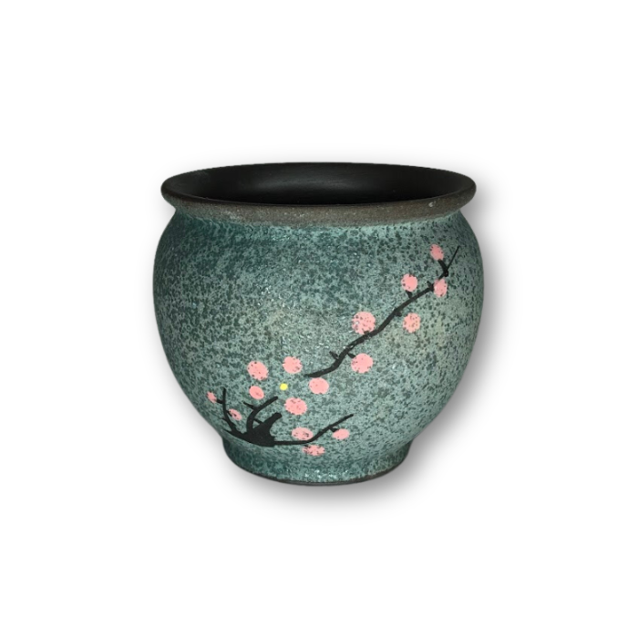 A blue-green ceramic pot featuring a cherry blossom branch design, perfect for indoor plants.