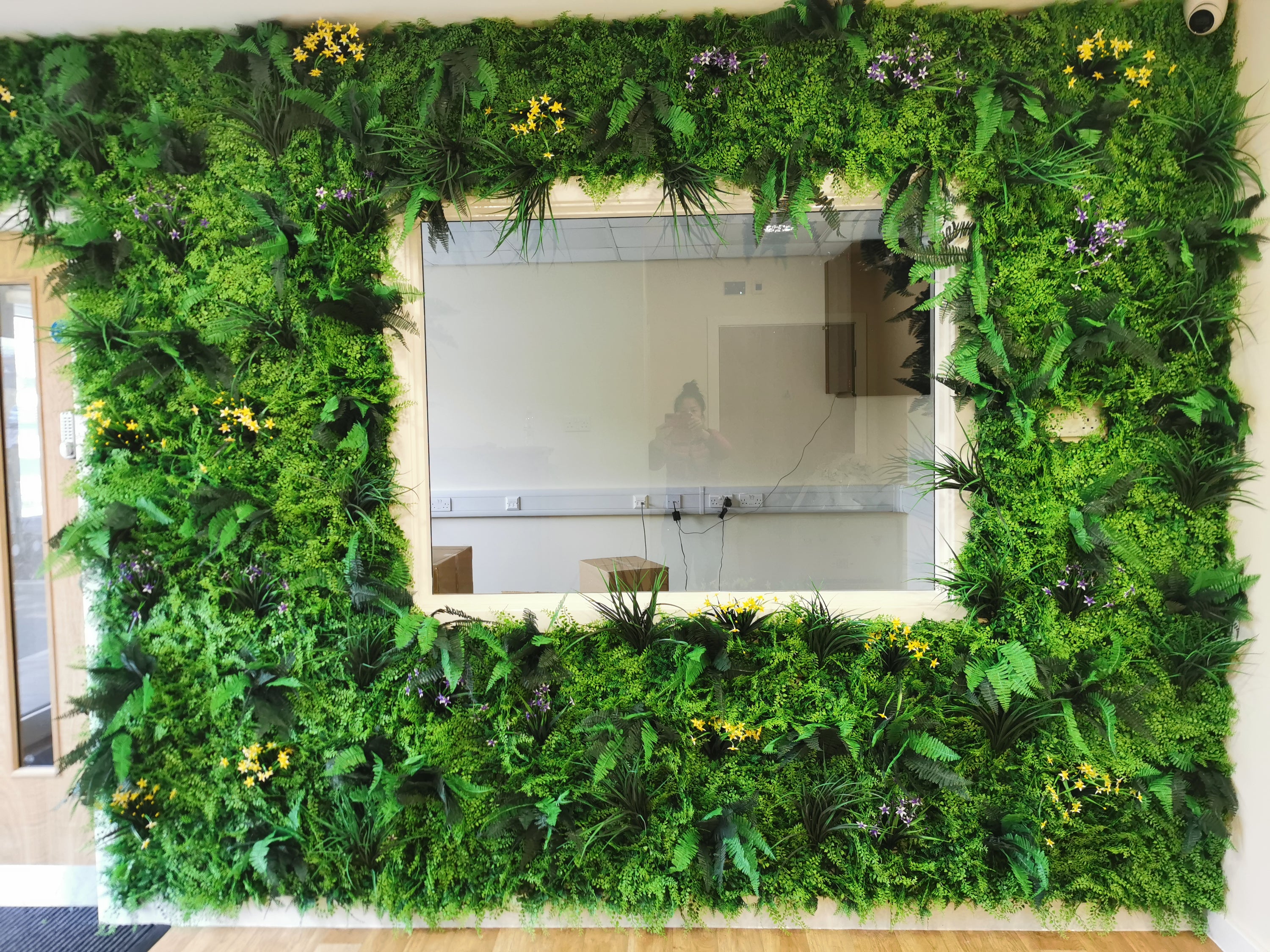 Flame Resistant Artificial Green Wall Hedge Panel measuring 100 x 100 cm, featuring a mix of lush leaves, grass, and fern for a dense, luxurious appearance.