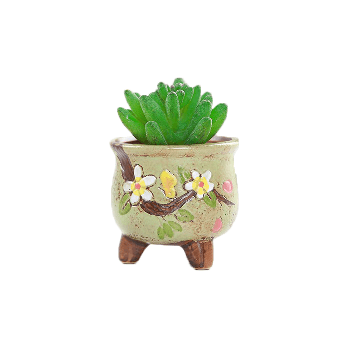 Green pear-shaped ceramic succulent pot with floral design, supported by three legs, featuring a drainage hole.