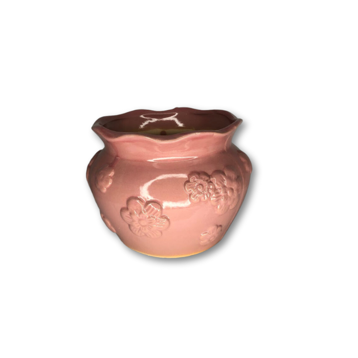 A charming pink glazed pot featuring a raised flower pattern, perfect for indoor plants.