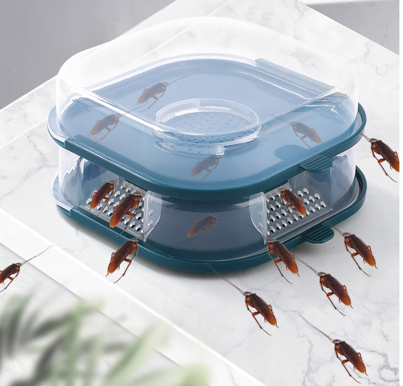 A blue reusable bugs trap box designed for catching cockroaches, featuring a trapdoor and bait compartment for effective pest control.