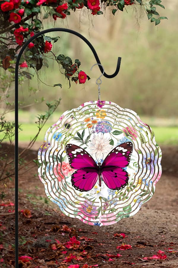 A vibrant fuchsia butterfly wind spinner, 10 inches in diameter, elegantly spinning in the garden, showcasing its double-sided design.