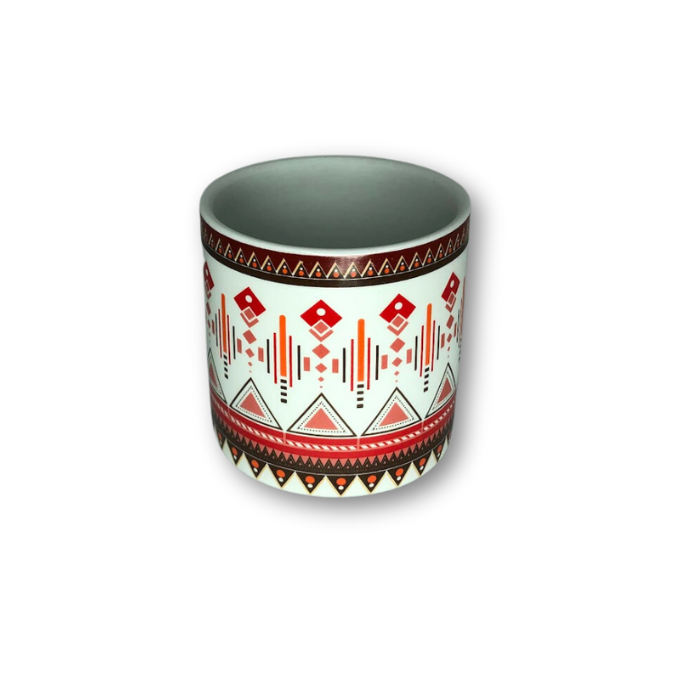 A stylish white cup pot featuring an intricate Aztec pattern, perfect for small plants.