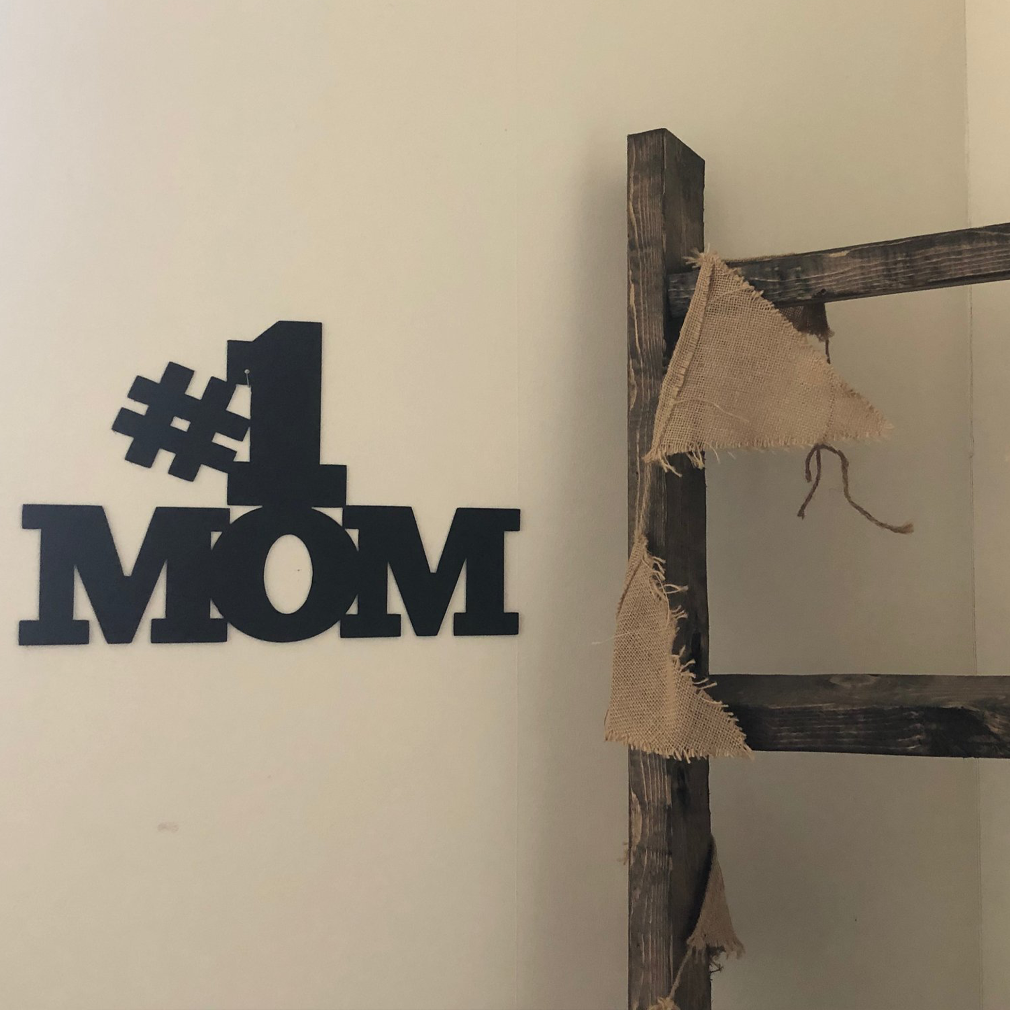 Elegant black metal wall art reading '#1 Mom', perfect for Mother's Day decor.