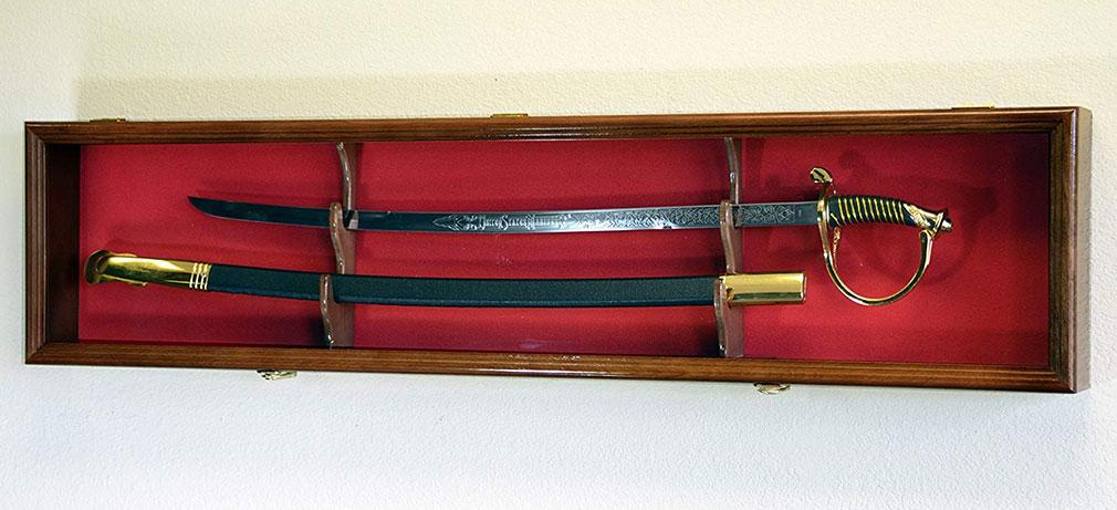 Elegant solid hardwood sword display case with felt background, showcasing a sword and scabbard, featuring brass hinges and a matching sword stand.