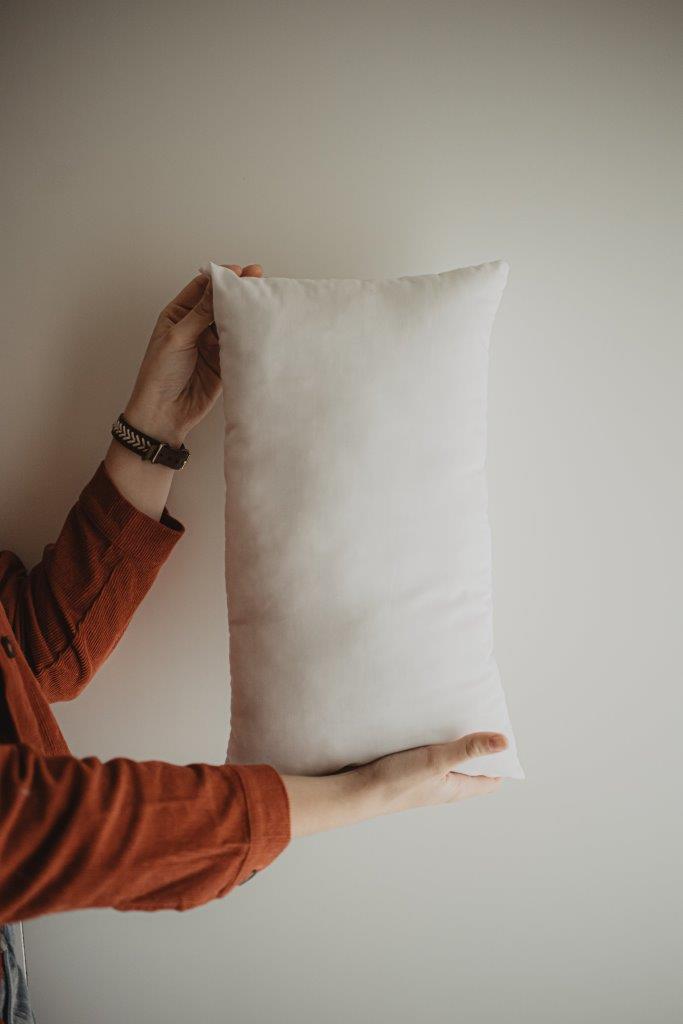 A plush 12x16 or 16x12 hypoallergenic polyester pillow insert, showcasing its soft texture and durable woven cotton blend fabric.