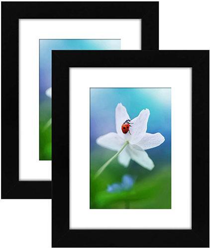 Two black 6x8 tabletop picture frames displaying 4x6 photos with white beveled mats, featuring shatterproof glass and easel stands.