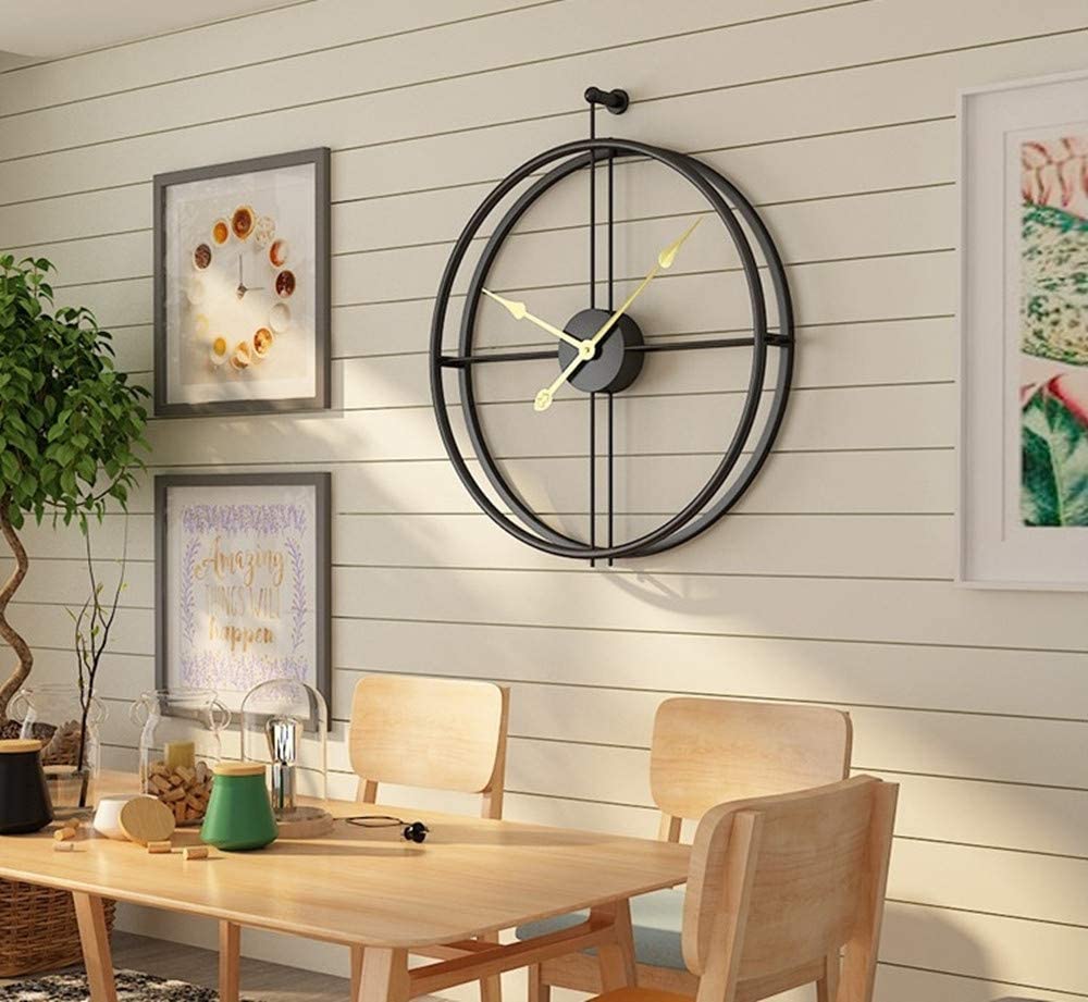 A stylish 20-inch black metal analog clock with a silver frame, showcasing a modern and simplistic design, perfect for home decor.