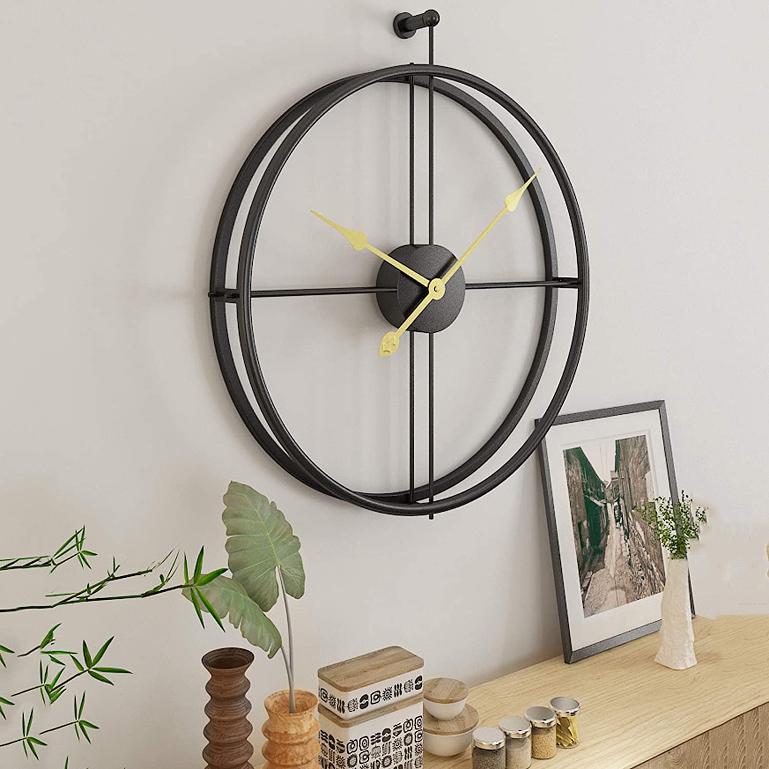 A stylish 20-inch black metal analog clock with a silver frame, showcasing a modern and simplistic design, perfect for home decor.