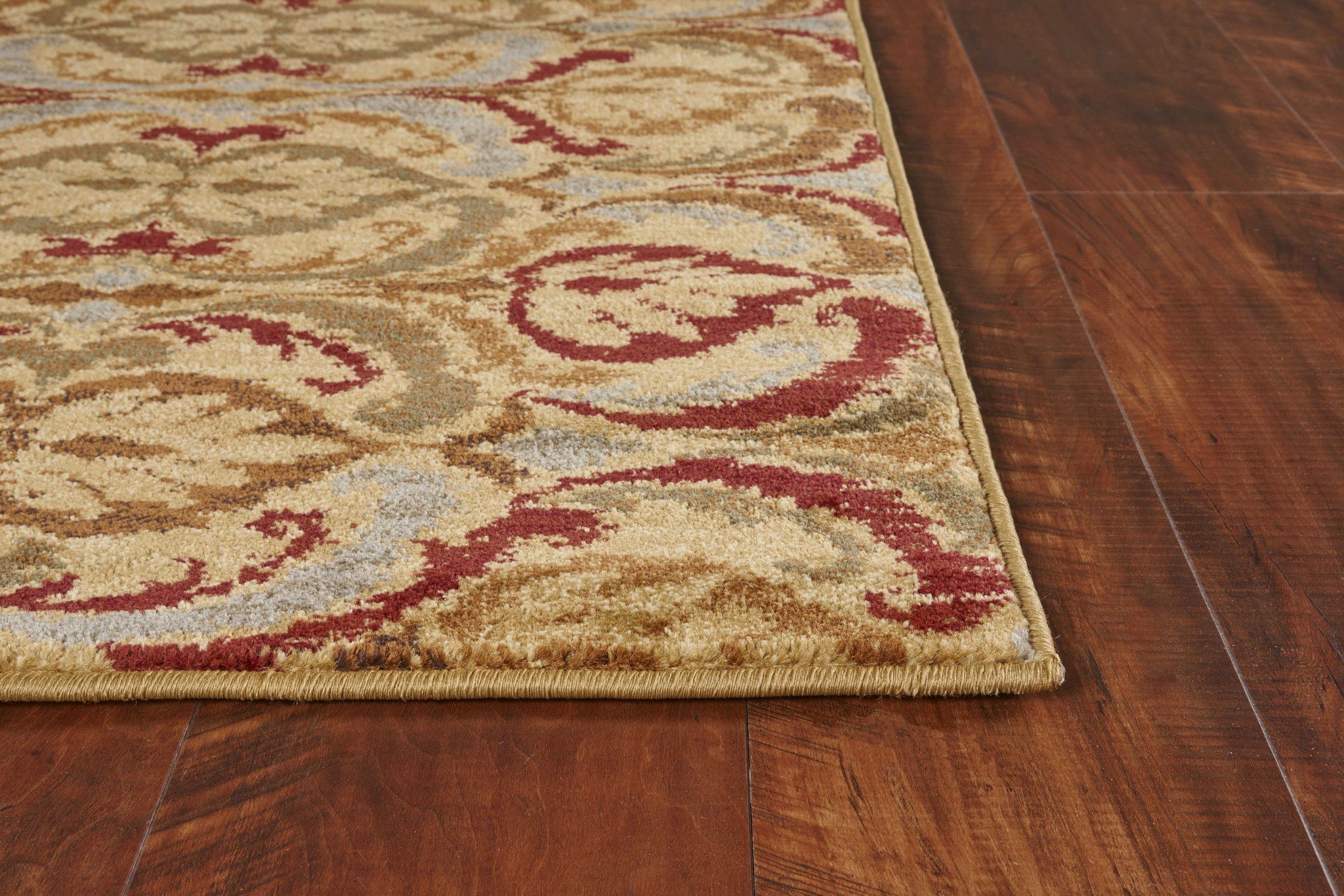 A 23" x 35" gold polypropylene rug featuring a stylish design, perfect for enhancing home decor.