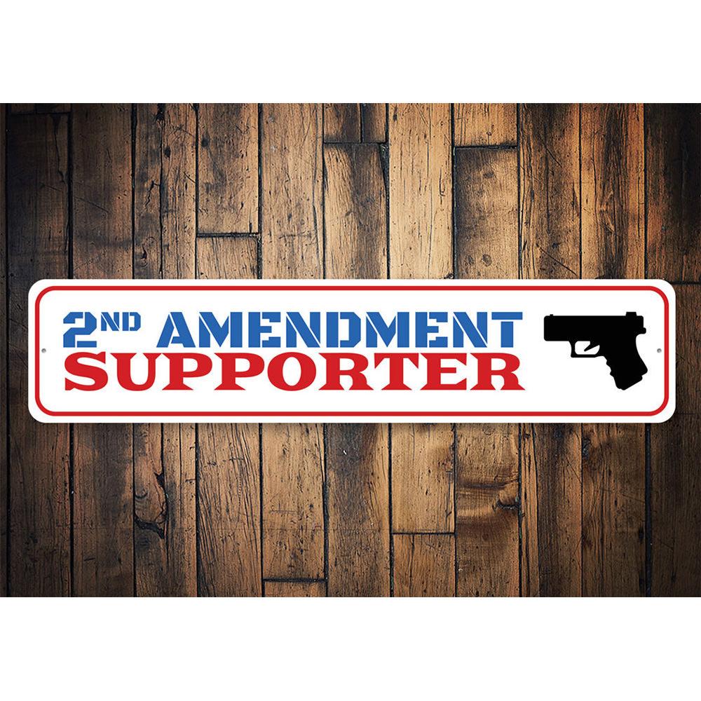 A decorative 2nd Amendment Supporter Sign made of aluminum, featuring bold text and a stylish design, suitable for indoor and outdoor display.