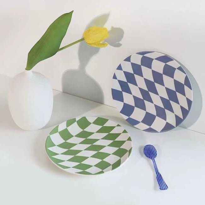 A set of four eco-friendly bamboo fiber checkered dinner plates in blue and green colors, showcasing their vibrant design and sturdy construction.