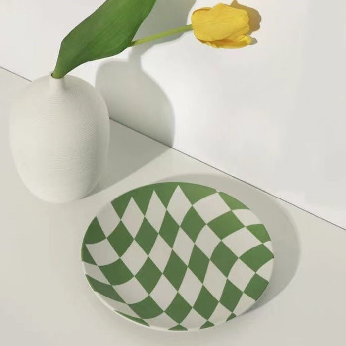 A set of four eco-friendly bamboo fiber checkered dinner plates in blue and green colors, showcasing their vibrant design and sturdy construction.