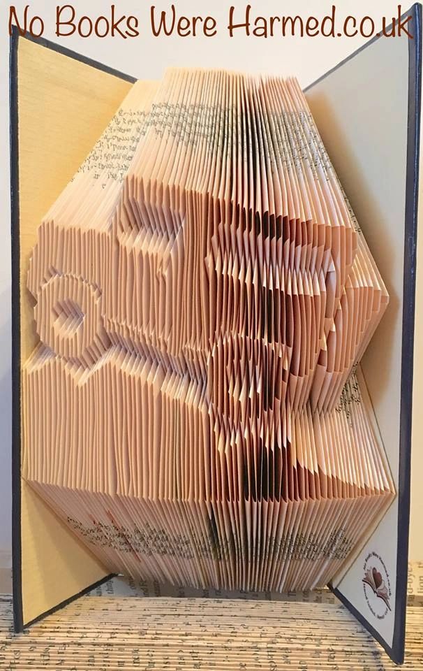 Hand-folded book art inspired by 4X4 off-roading, showcasing unique designs from vintage books.