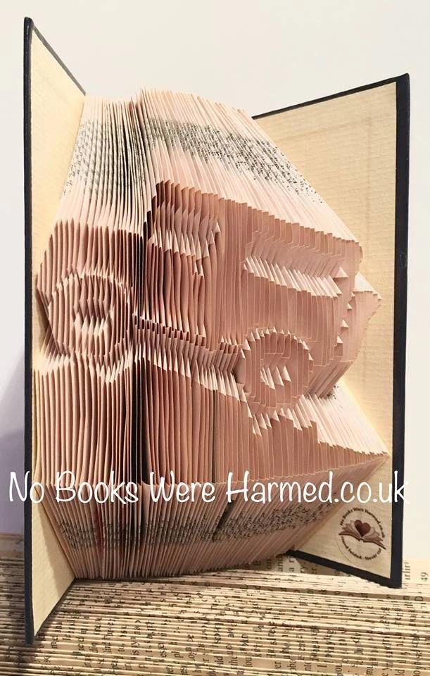 Hand-folded book art inspired by 4X4 off-roading, showcasing unique designs from vintage books.