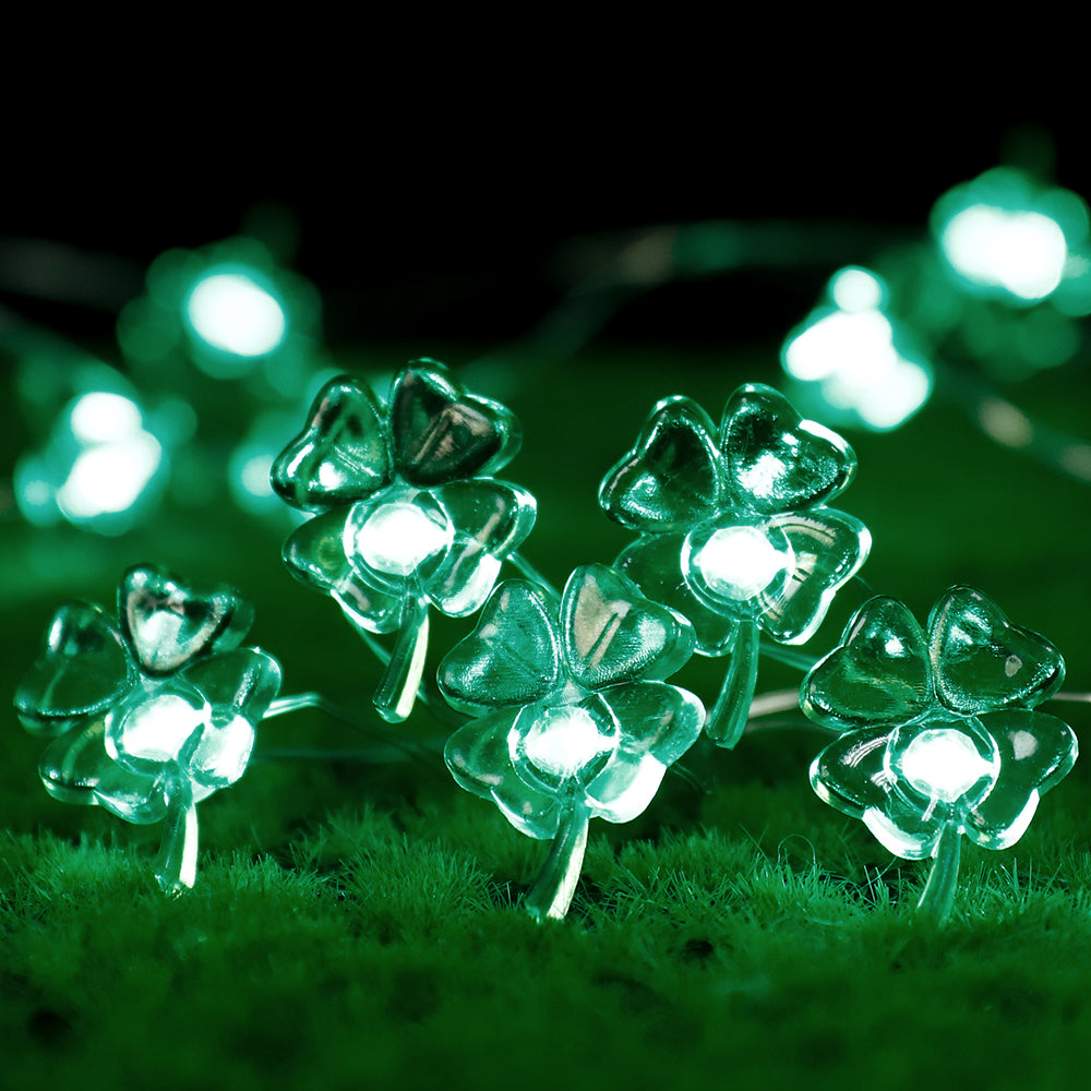 9.8FT string light featuring 30 handmade four-leaf clover LED lights, glowing green for festive decoration.