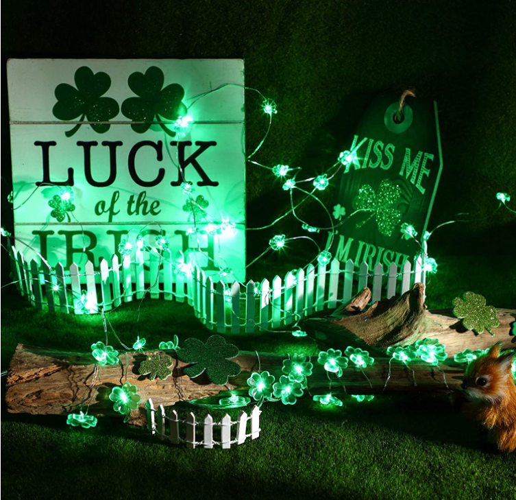 9.8FT string light featuring 30 handmade four-leaf clover LED lights, glowing green for festive decoration.