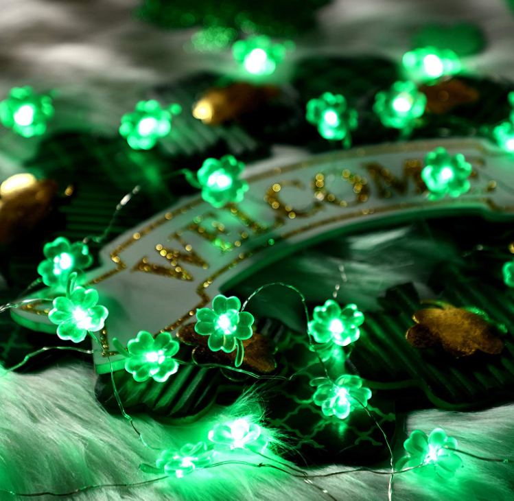 9.8FT string light featuring 30 handmade four-leaf clover LED lights, glowing green for festive decoration.