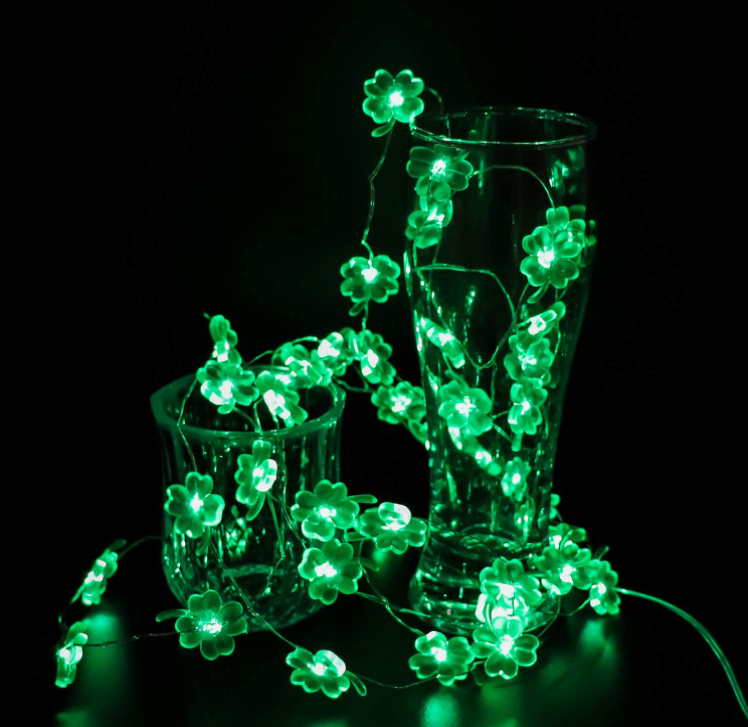 9.8FT string light featuring 30 handmade four-leaf clover LED lights, glowing green for festive decoration.