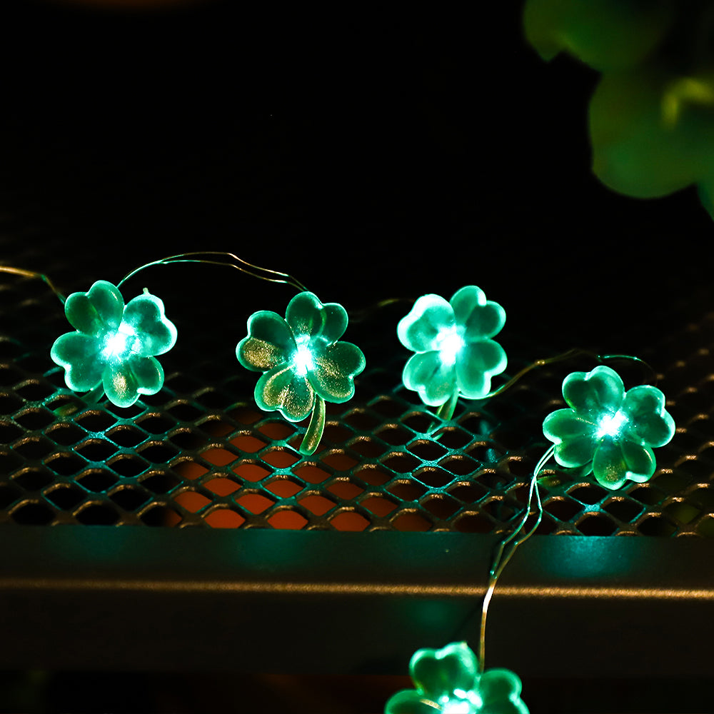 9.8FT string light featuring 30 handmade four-leaf clover LED lights, glowing green for festive decoration.