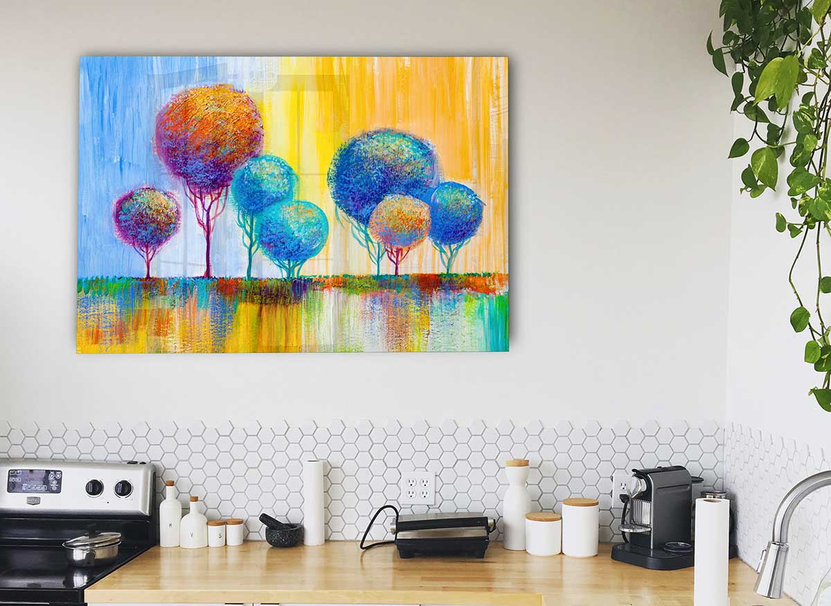 A modern glass print featuring a group of trees, showcasing vibrant colors and intricate details, perfect for home decor.