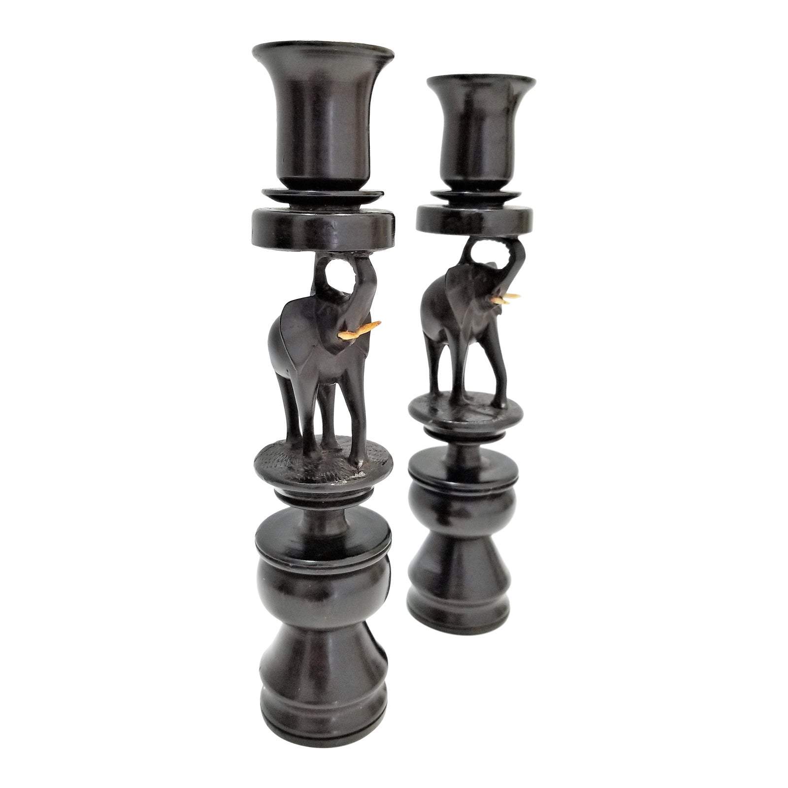 A pair of elegant Elephant Curved Ebony Candle Holders made from rich ebony wood, showcasing a unique curved design.