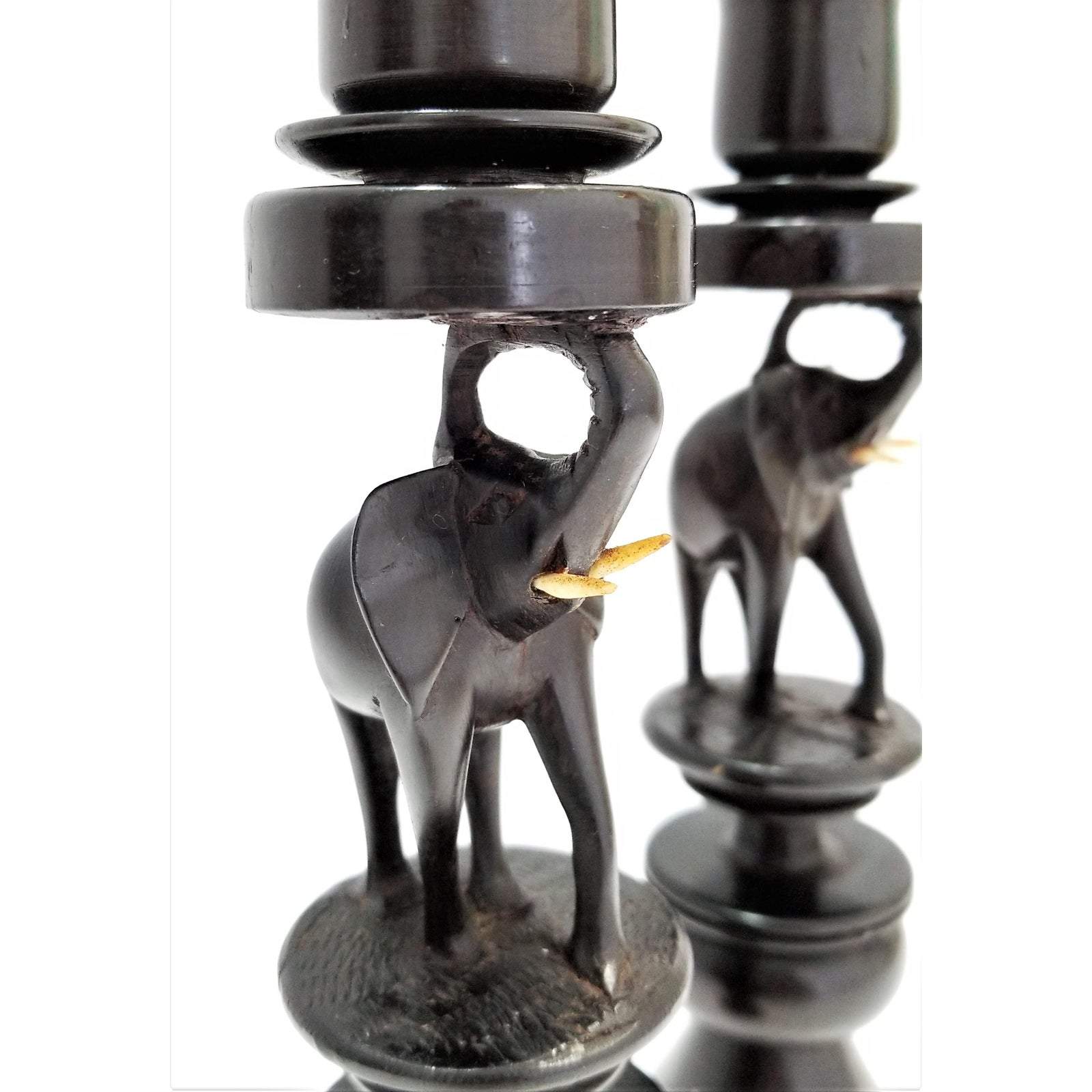 A pair of elegant Elephant Curved Ebony Candle Holders made from rich ebony wood, showcasing a unique curved design.