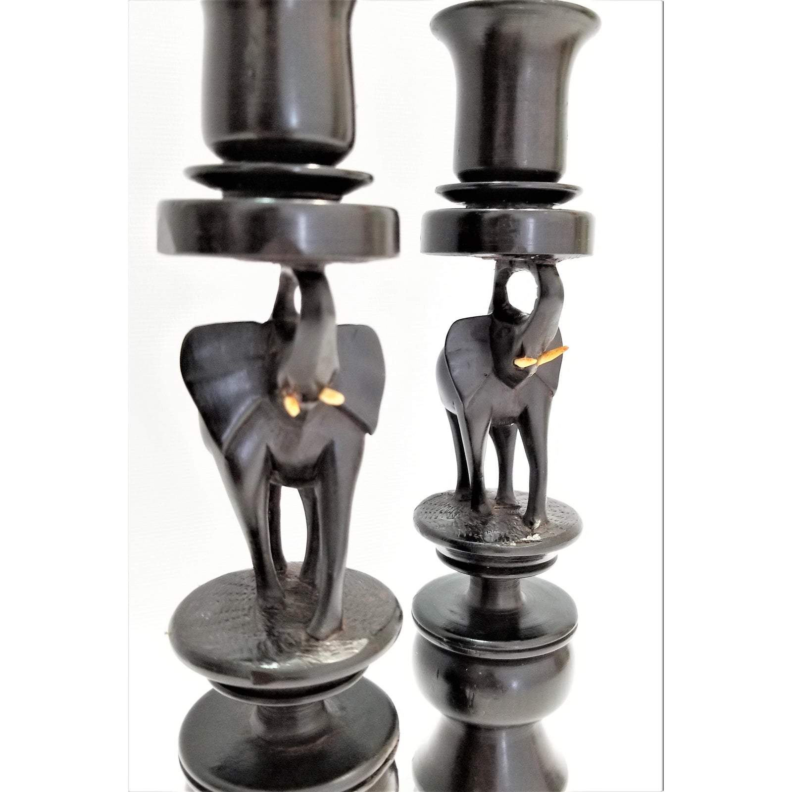 A pair of elegant Elephant Curved Ebony Candle Holders made from rich ebony wood, showcasing a unique curved design.