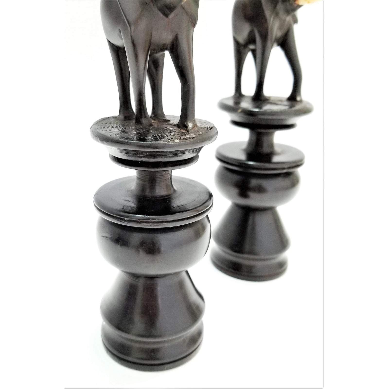 A pair of elegant Elephant Curved Ebony Candle Holders made from rich ebony wood, showcasing a unique curved design.