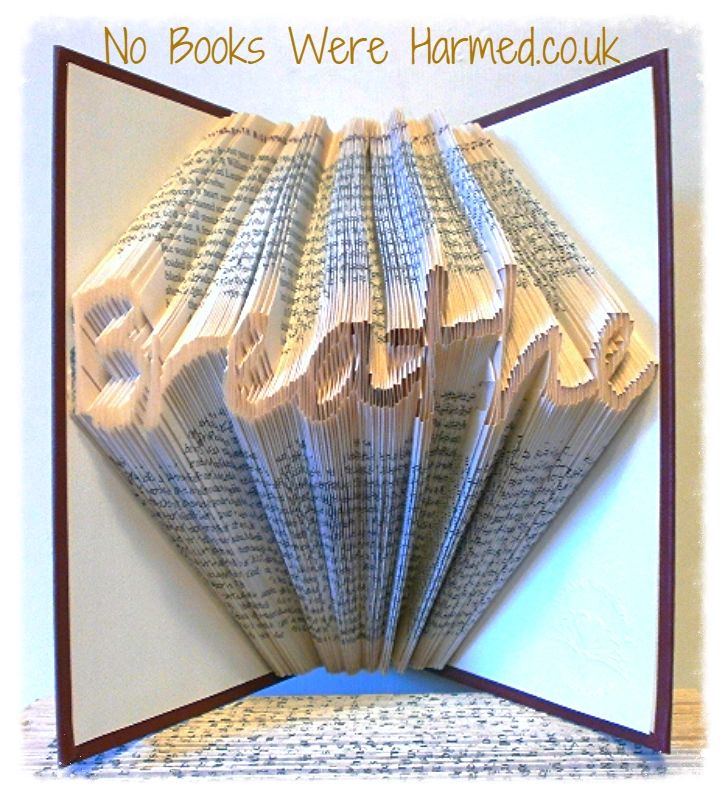 Handcrafted 'Breathe' art piece made from vintage book pages, showcasing intricate folds and unique design.