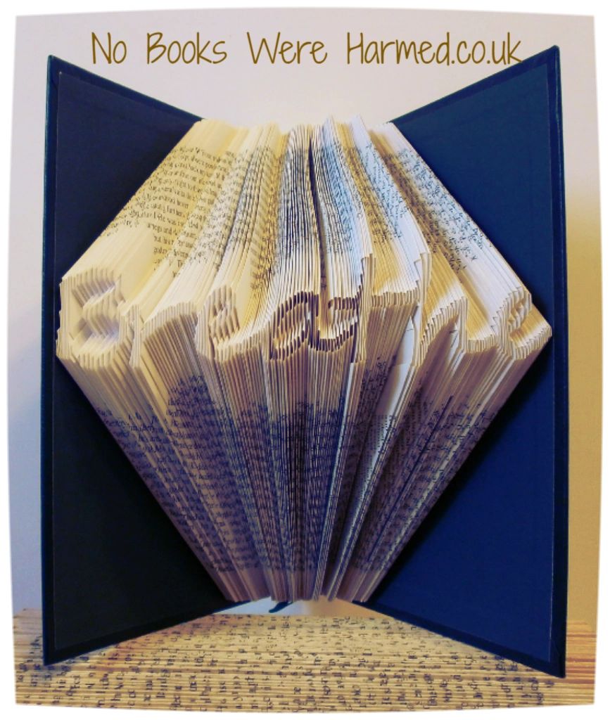 Handcrafted 'Breathe' art piece made from vintage book pages, showcasing intricate folds and unique design.