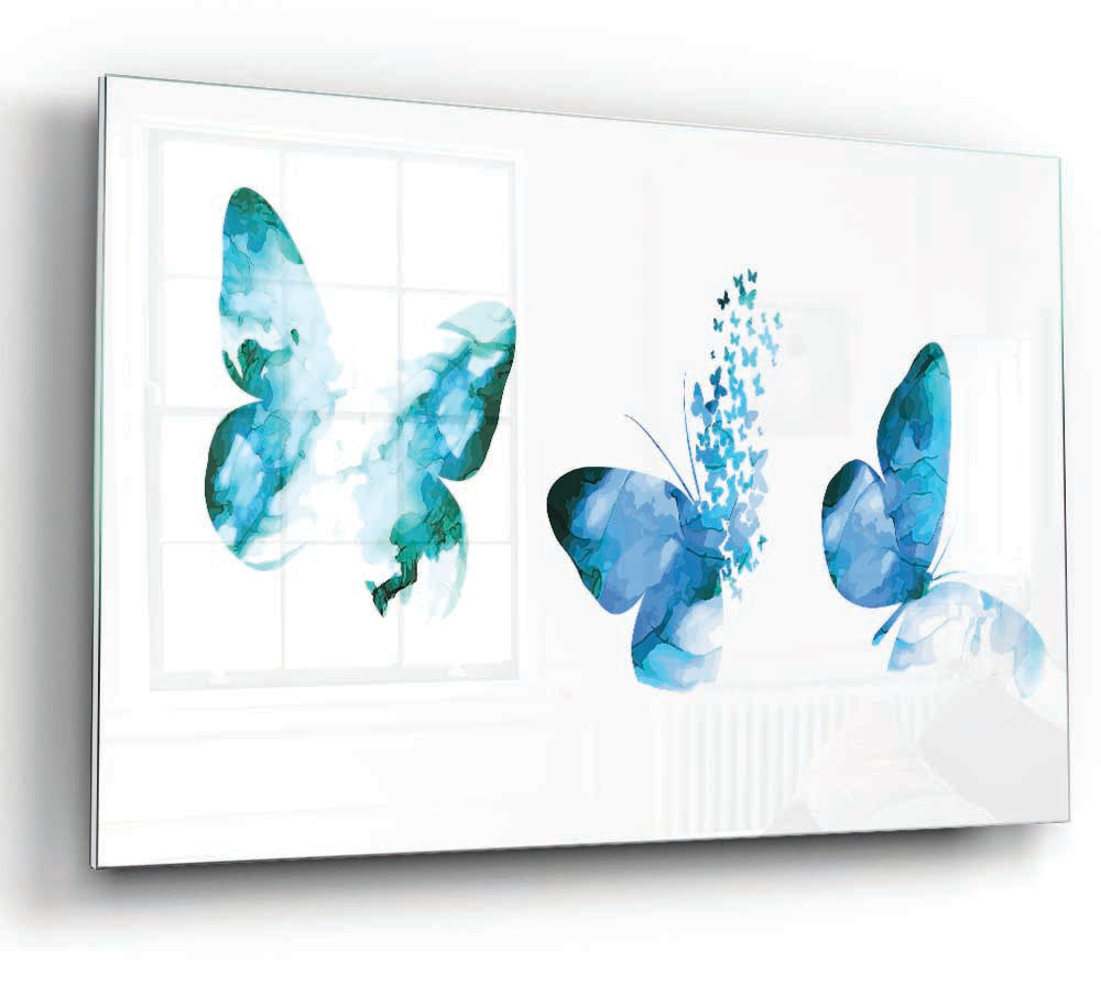 A beautiful glass print featuring three blue butterflies, showcasing vibrant colors and intricate details, perfect for modern home decor.