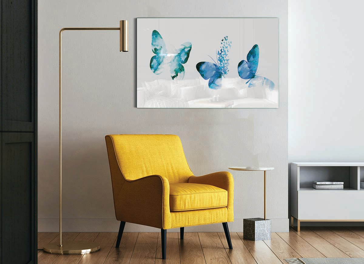 A beautiful glass print featuring three blue butterflies, showcasing vibrant colors and intricate details, perfect for modern home decor.