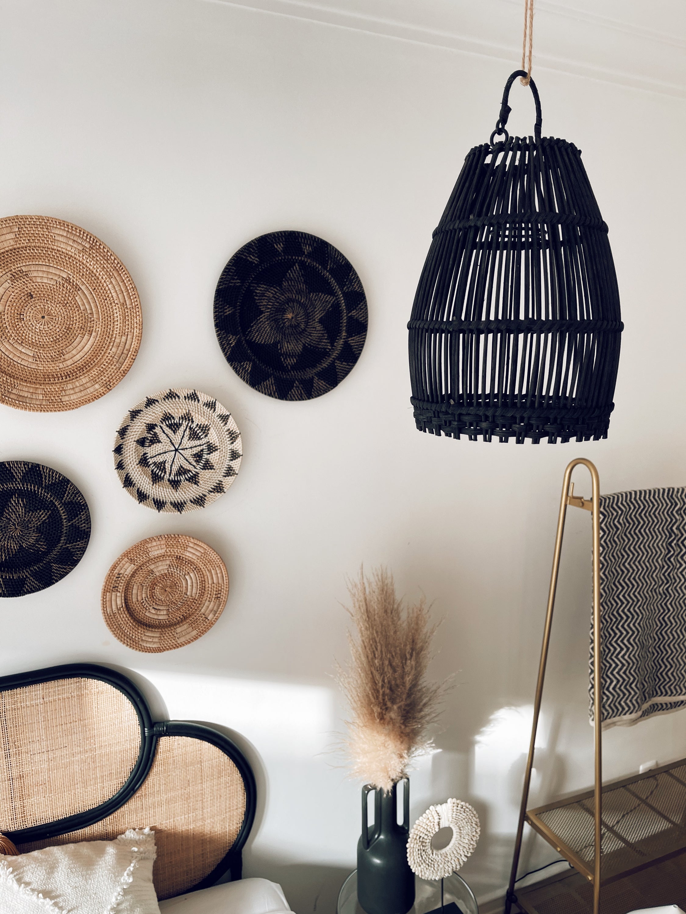 Ayana Black Rattan Lampshade hanging elegantly, showcasing its intricate handmade design and natural texture.