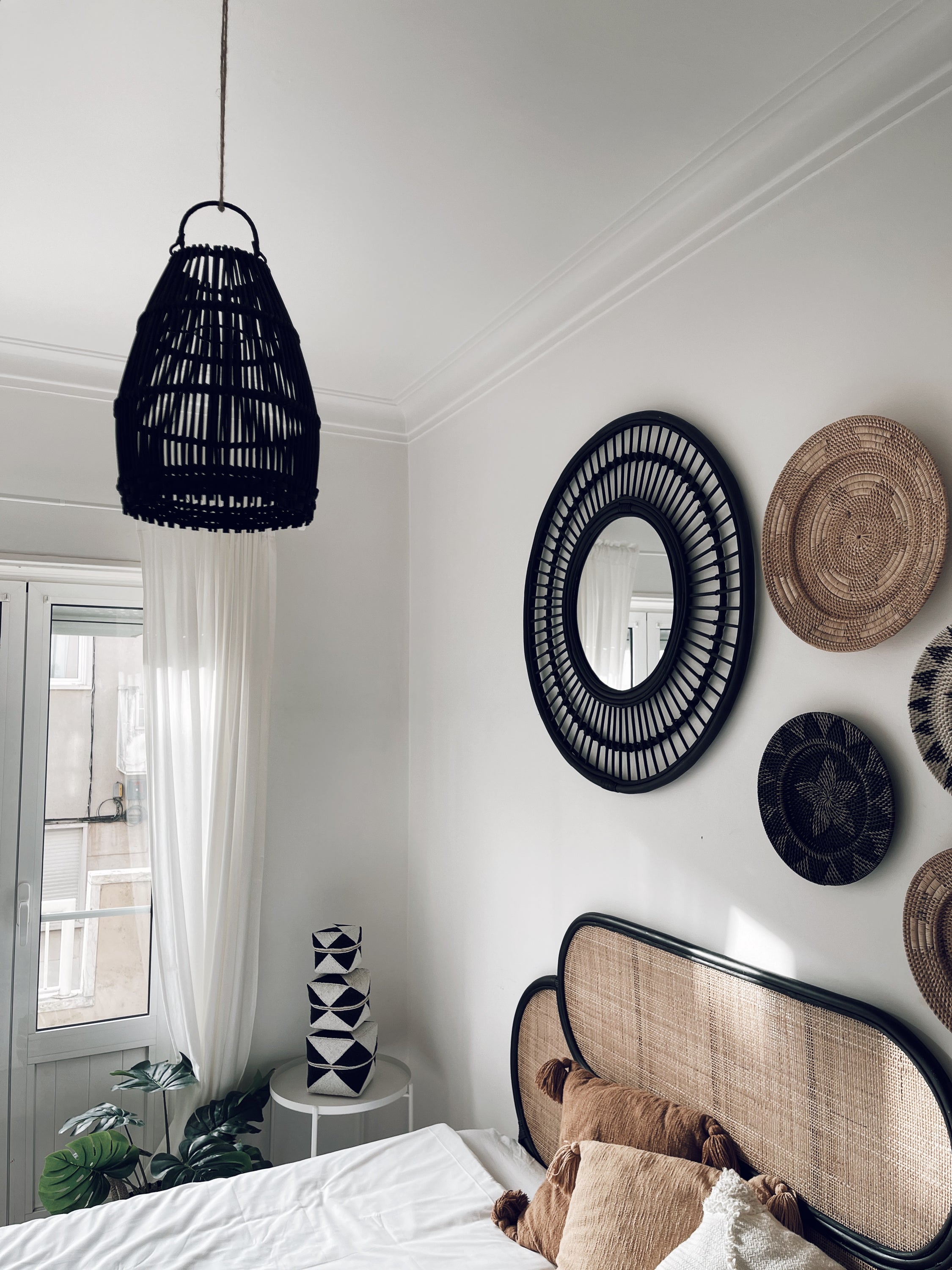 Ayana Black Rattan Lampshade hanging elegantly, showcasing its intricate handmade design and natural texture.