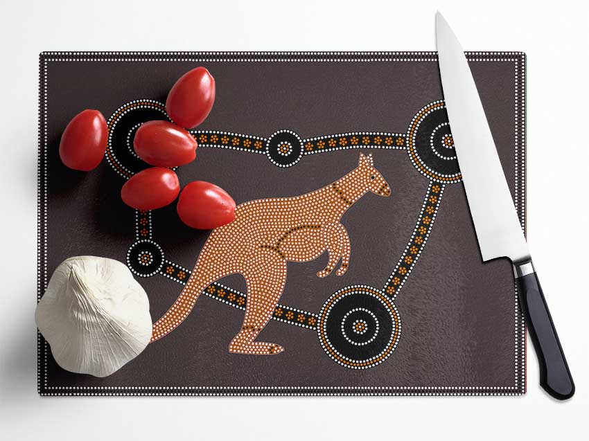 Aboriginal Kangaroo chopping board made from tempered glass with chinchilla ripple effect and anti-slip feet.