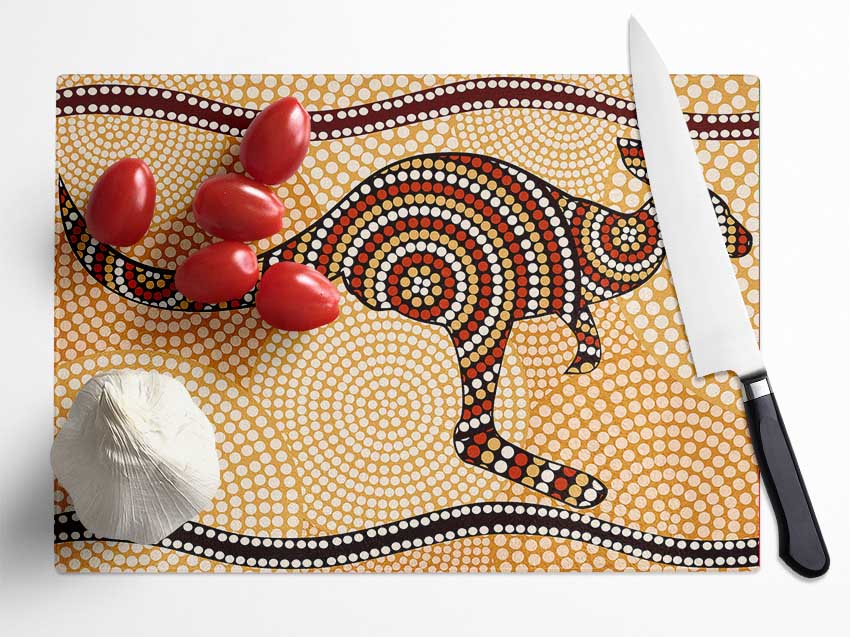 Aboriginal Kangaroo 4 chopping board made from tempered glass with chinchilla ripple effect and anti-slip feet.