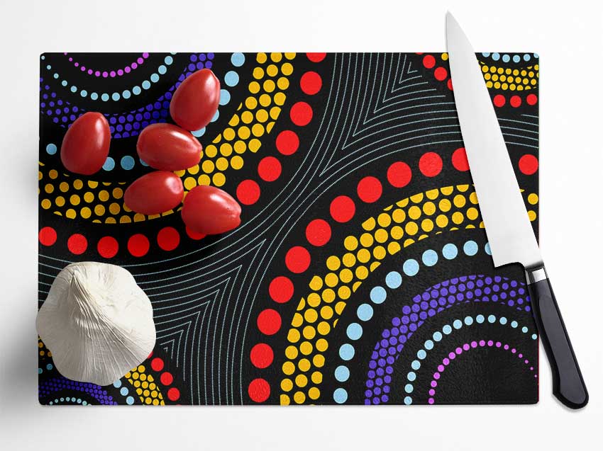 Aboriginal Pattern 11 chopping board made of tempered glass with a chinchilla ripple effect and anti-slip feet.